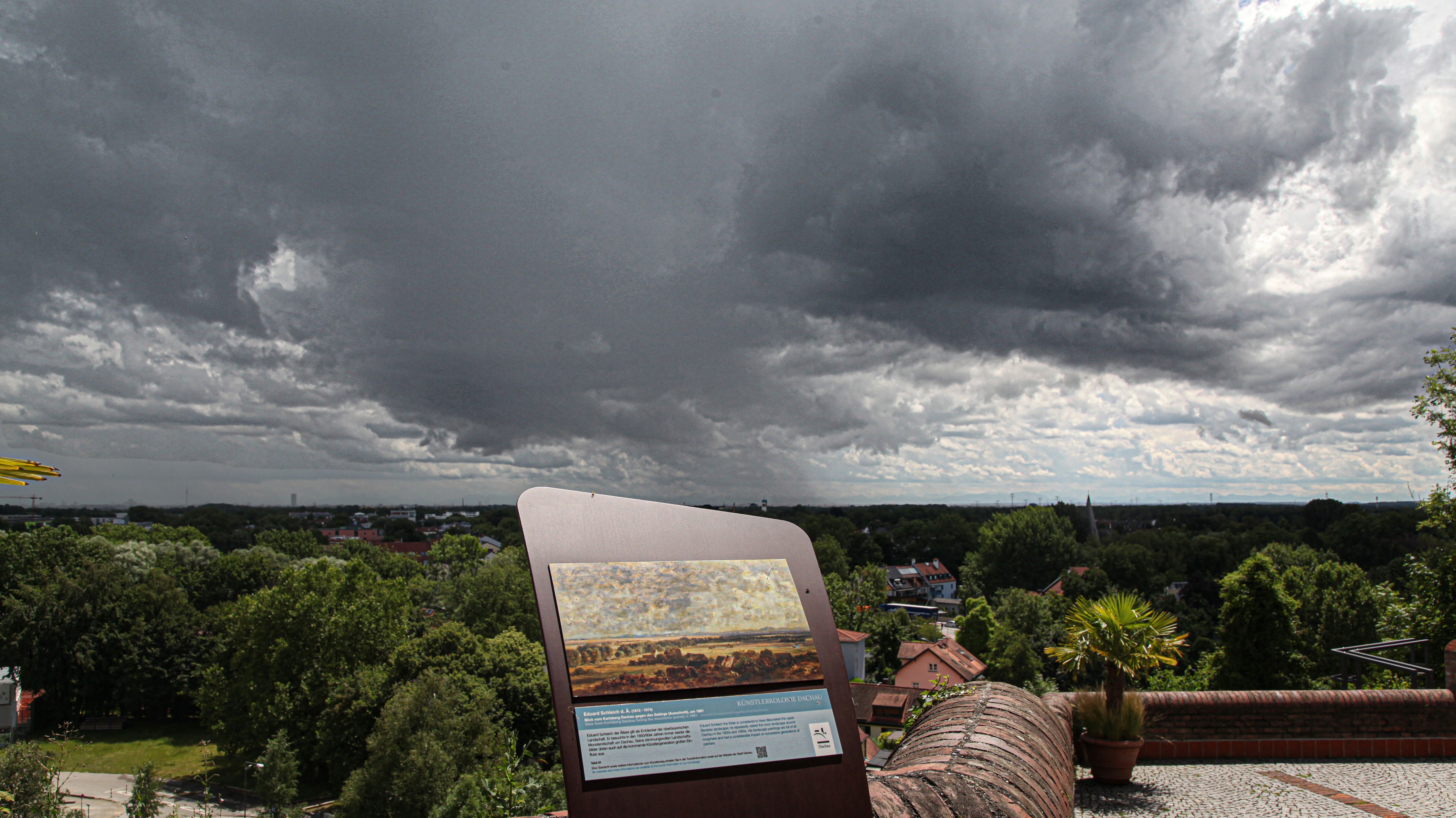 Starting point of the Artist path: The Town Hall Terrace. Picture shows information board with painting on it. In the background you can see the area today.