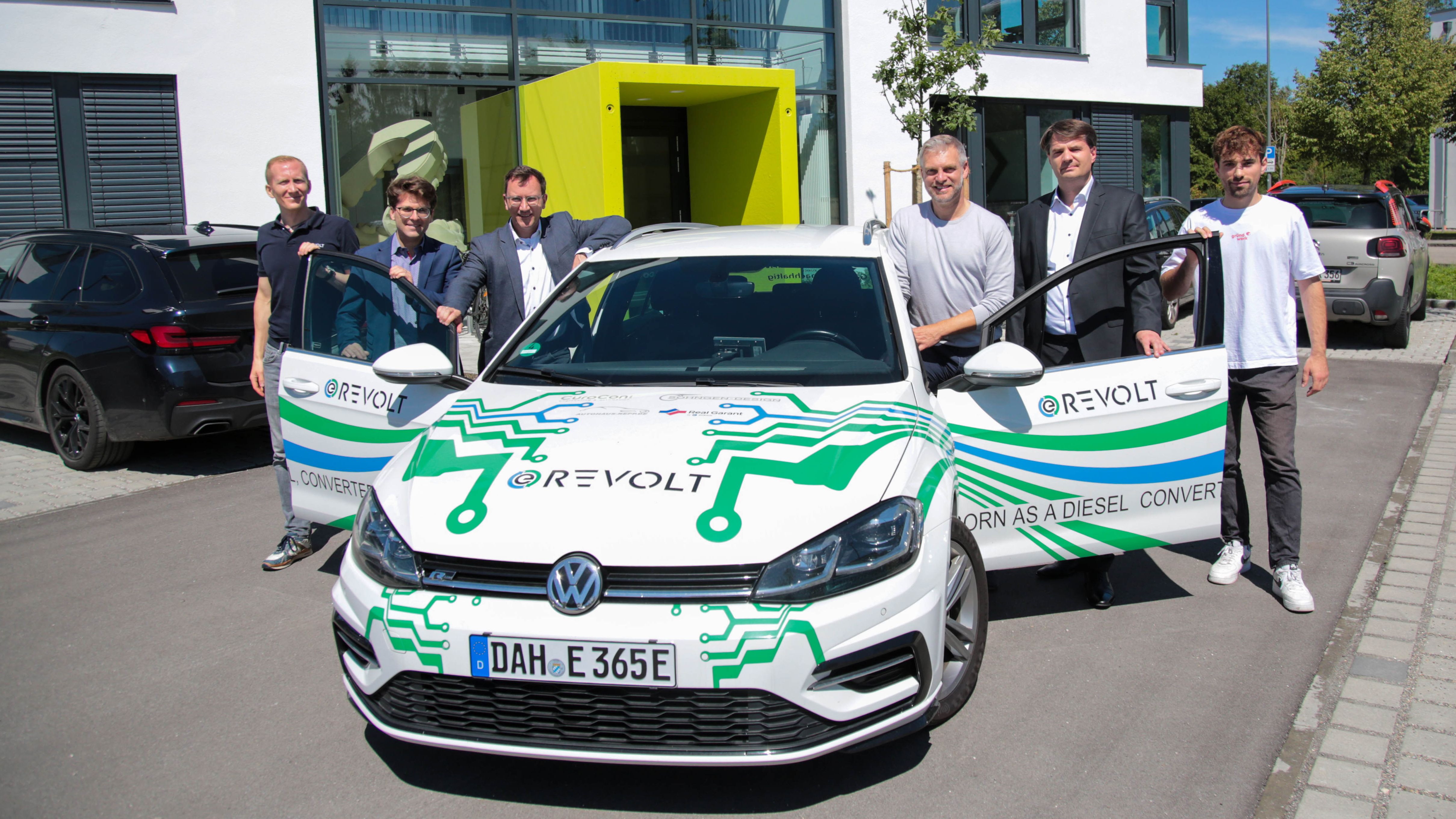 Auf dem Foto (v.l.n.r.): Sebastian Hunold, OB Florian Hartmann, Wirtschaftsreferent Andreas Gahr, Ralf Schollenberger, Alexander Broschell und Fabian Wilhelm neben einem E-Auto