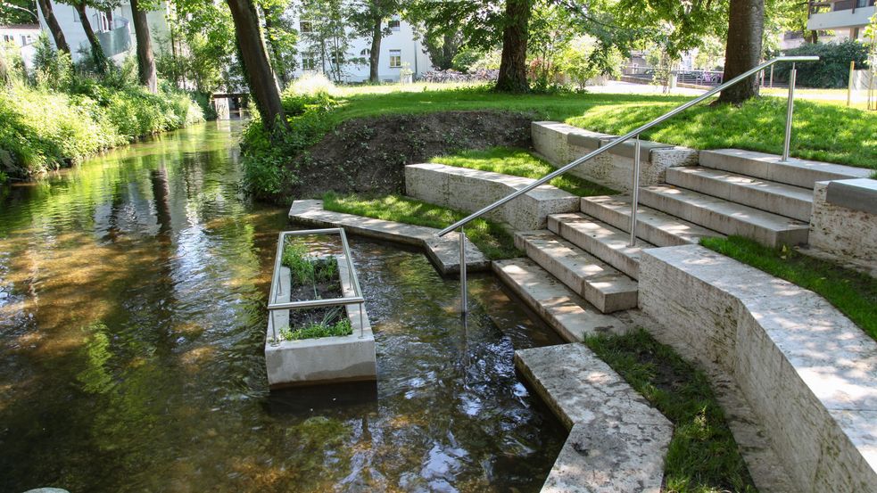 Photo of water treading with stone steps leading into the stream and a hand rail at the Kalterbach stream in Dachau. Photo: City of Dachau