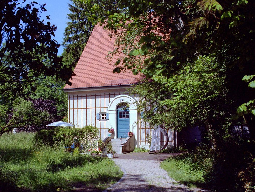 Künstlerhaus Carl Thiemann, kleines Haus mit blauer Tür, in großem Garten.