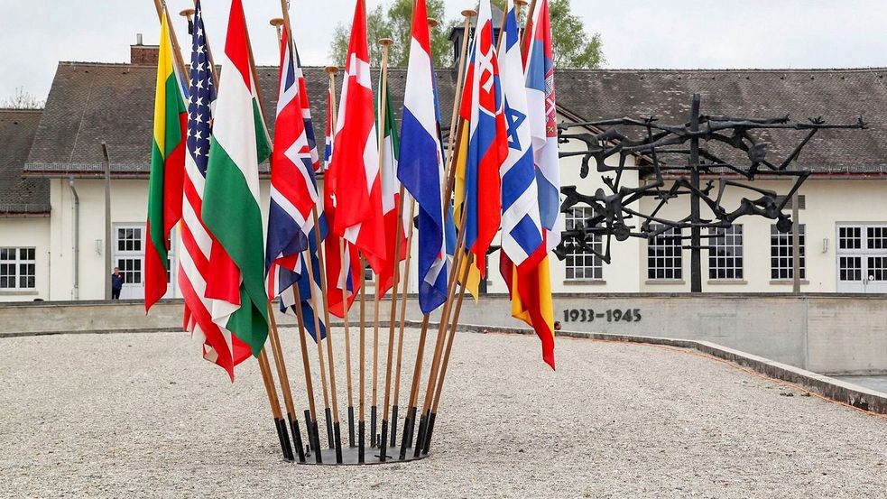 Photo of internatuional flags at Concentration Camp Memorial Site Dachau with jour house in the back ground. Photo: City of Dachau