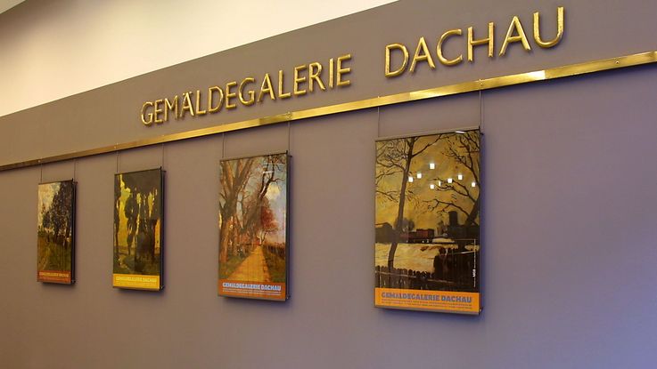 Photo of the interior of Dachau Paintings Gallery with posters and letters on coloured wall. Photo: Zweckverband Dachauer Galerien und Museen