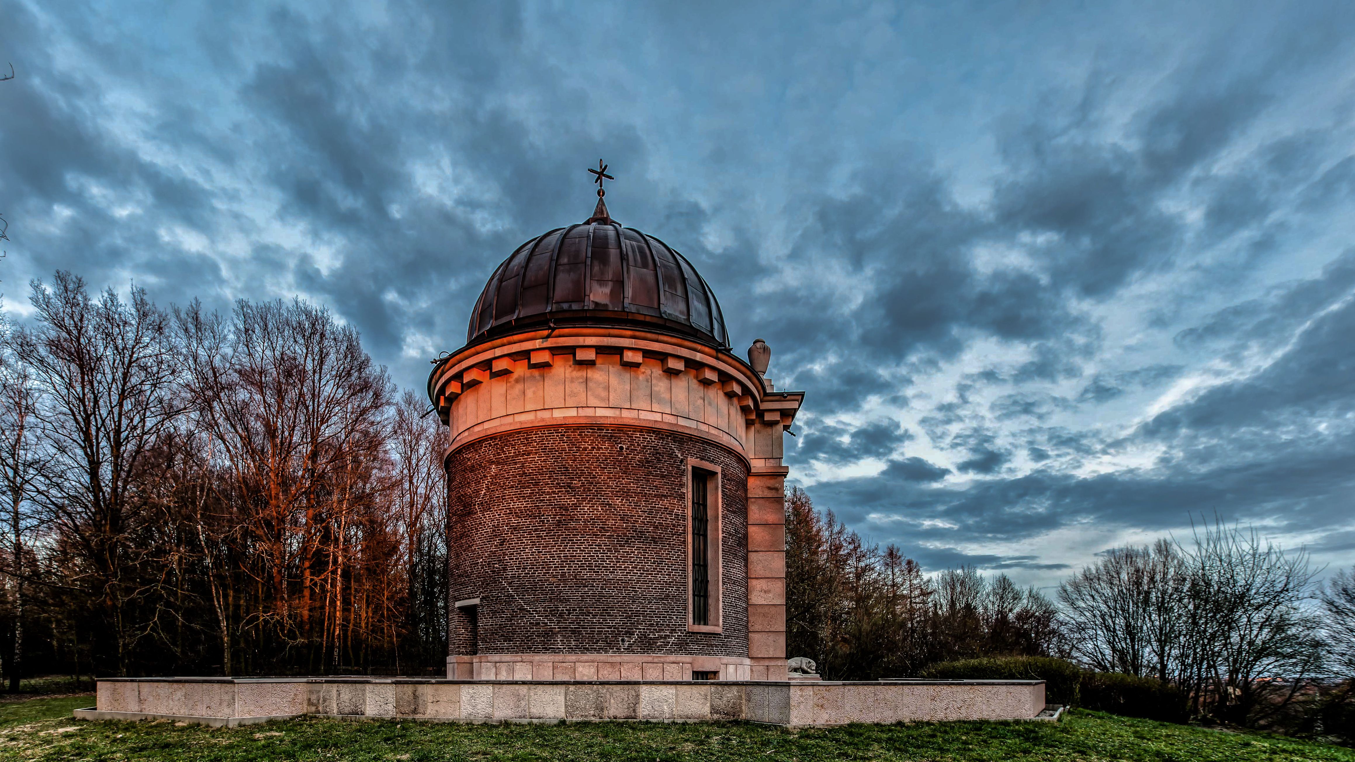 Italian memorial chapel "Regina Pacis" in reddish light with dark clouds in the background